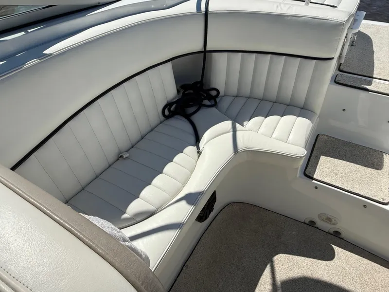 Slide: The Image of Interior of a 2002 Cobalt 262 boat with white cushioned seating. - 12
