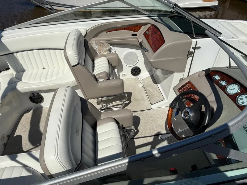 Slide: The Image of Interior of a 2002 Cobalt 262 boat with white leather seating and wood accents. - 4
