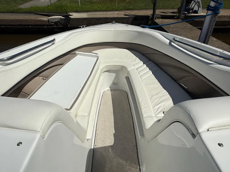 Slide: The Image of Interior of a 2002 Cobalt 262 boat with white seating and clean design. - 6