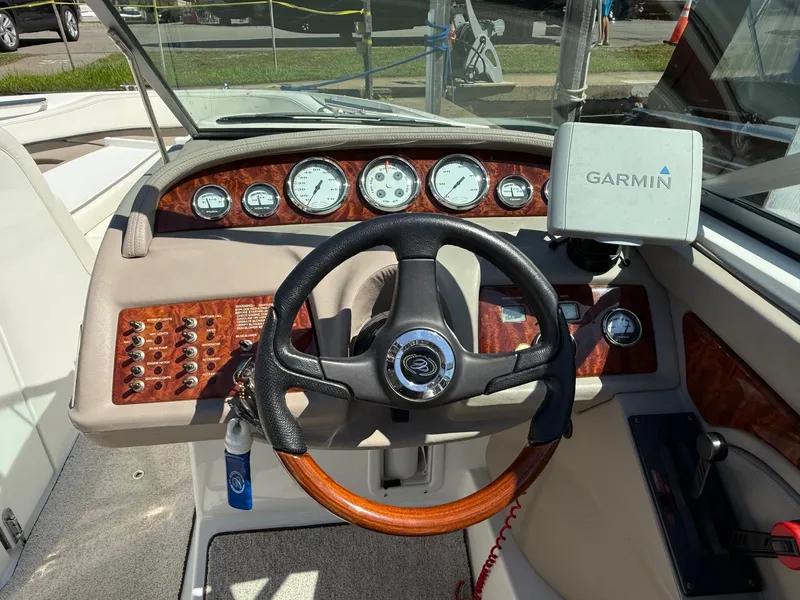 Slide: The Image of Steering wheel and dashboard of a 2002 Cobalt 262 boat with Garmin navigation system. - 7