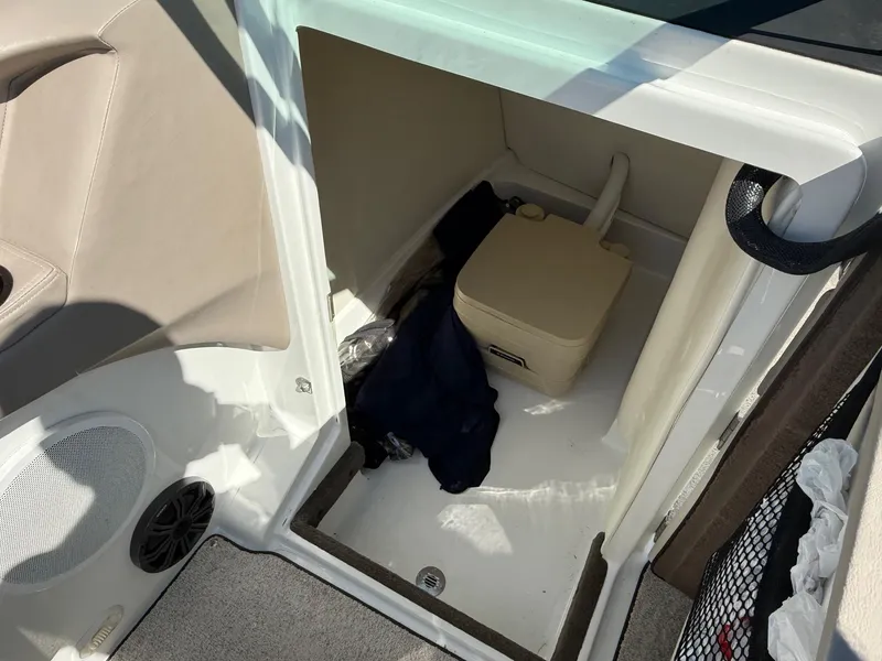 Slide: The Image of 2002 Cobalt 262 boat interior with storage compartment and portable toilet. - 8