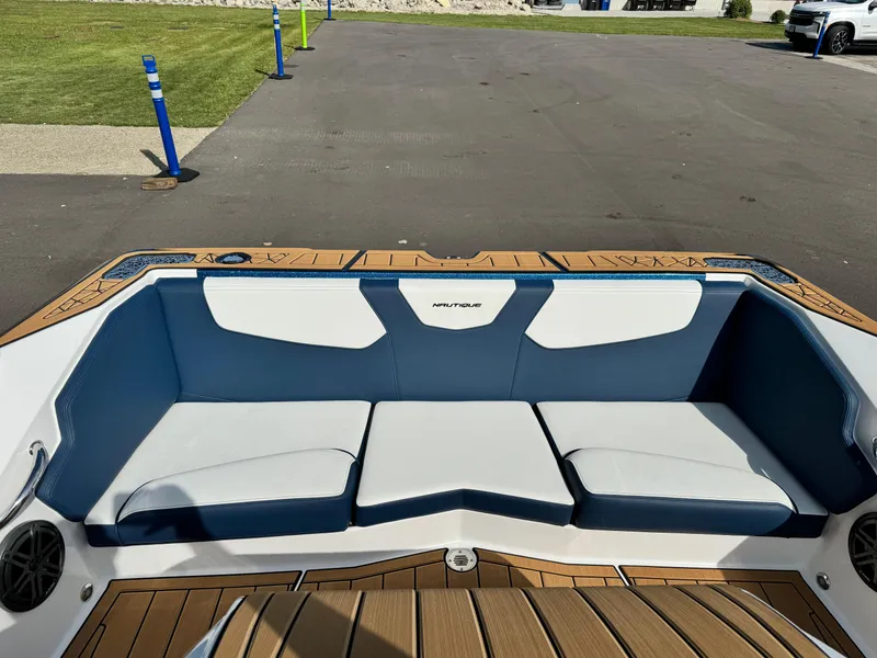 Slide: The Image of 2025 Nautique Ski 200 boat interior with blue and white seating. - 12