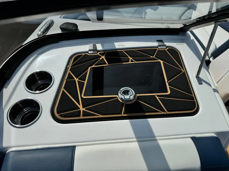 Slide: The Image of 2025 Nautique Ski 200 dashboard with geometric design and cup holders. - 21