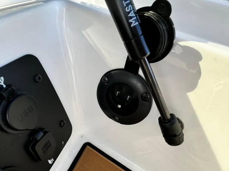 Slide: The Image of 2025 Nautique Ski 200 boat dashboard with USB port and hydraulic support. - 23