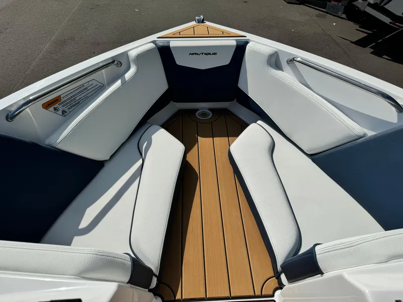 Slide: The Image of 2025 Nautique Ski 200 boat interior with cushioned seating and teak flooring. - 33