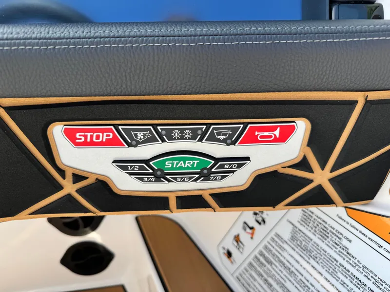 Slide: The Image of Control panel of 2025 Nautique Ski 200 boat with start and stop buttons. - 8