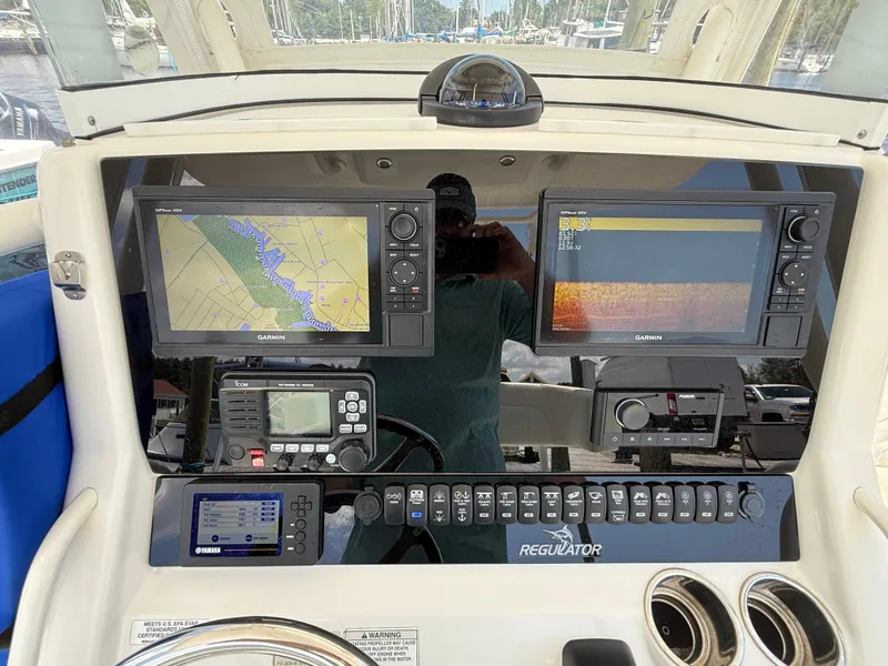 Slide: The Image of 2018 Regulator 23 boat dashboard with Garmin navigation and control systems. - 17