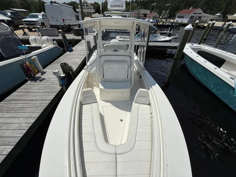 Slide: The Image of 2018 Regulator 23 boat docked, featuring spacious seating and Garmin equipment. - 20