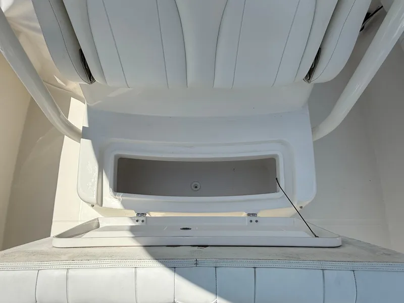 Slide: The Image of 2018 Regulator 23 boat seat with open storage compartment. - 27
