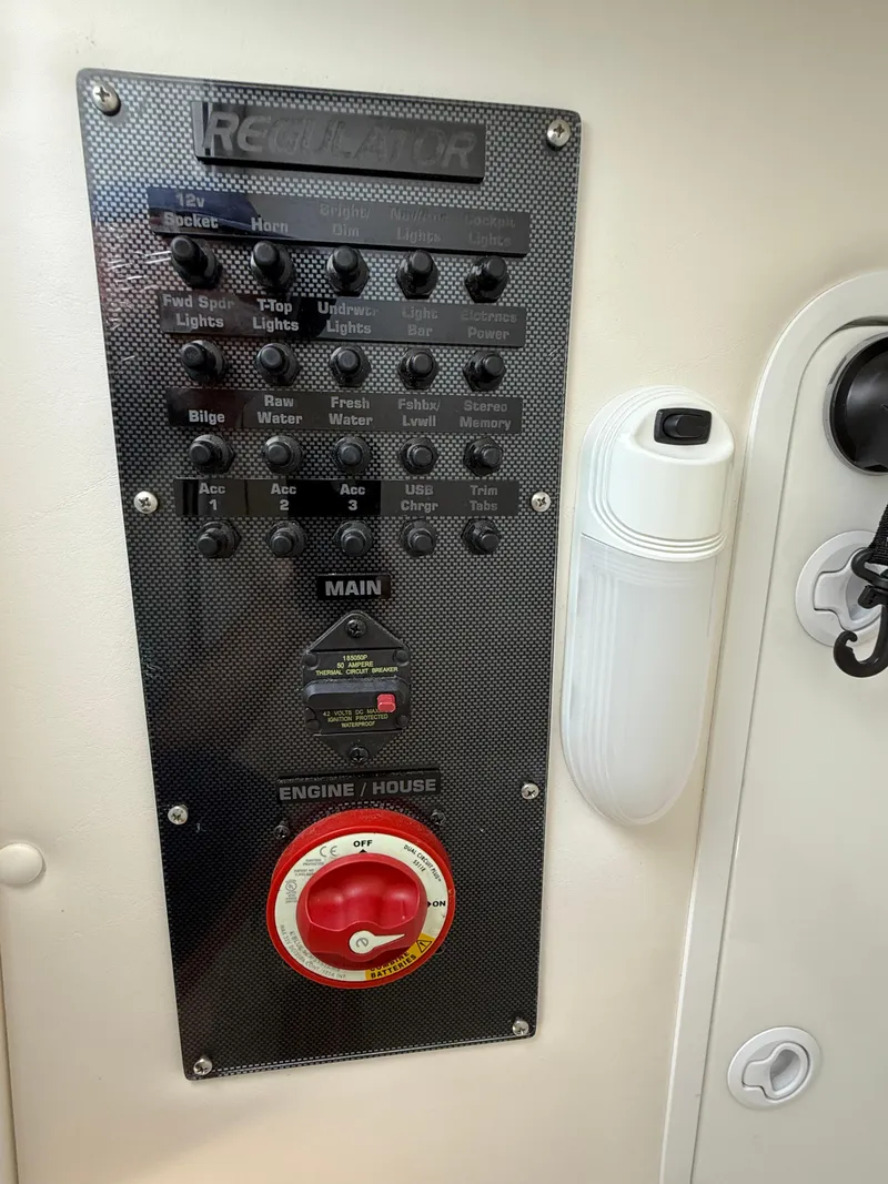 Slide: The Image of Control panel of a 2018 Regulator 23 boat with labeled switches and dials. - 28