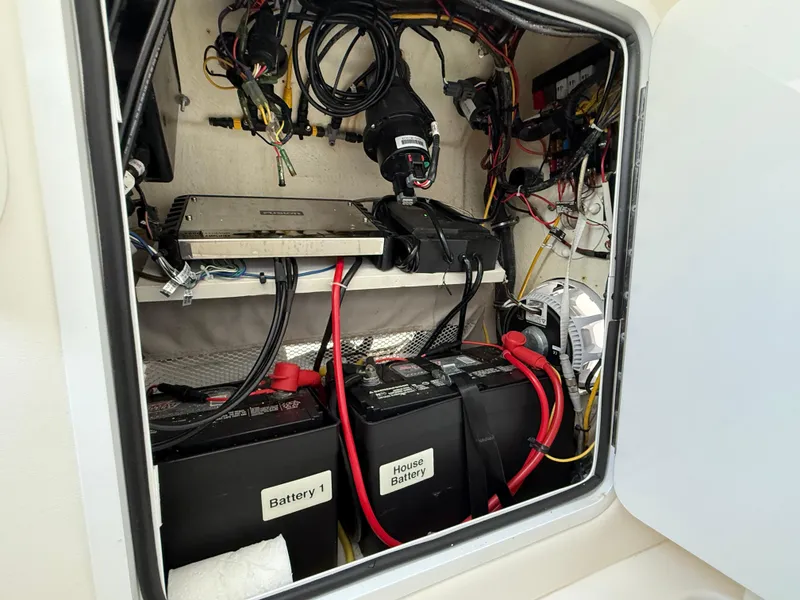 Slide: The Image of 2018 Regulator 23 boat battery compartment with wiring and labeled batteries. - 32