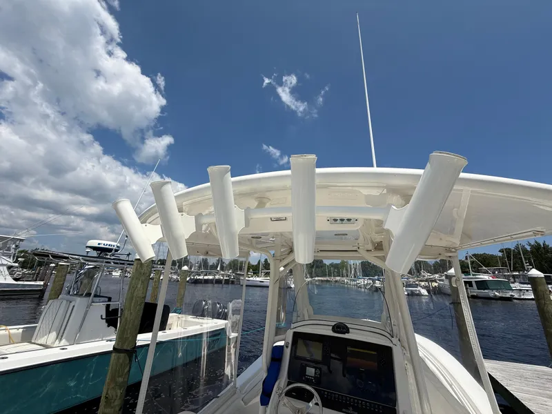 Slide: The Image of 2018 Regulator 23 boat docked at marina under clear blue sky. - 33