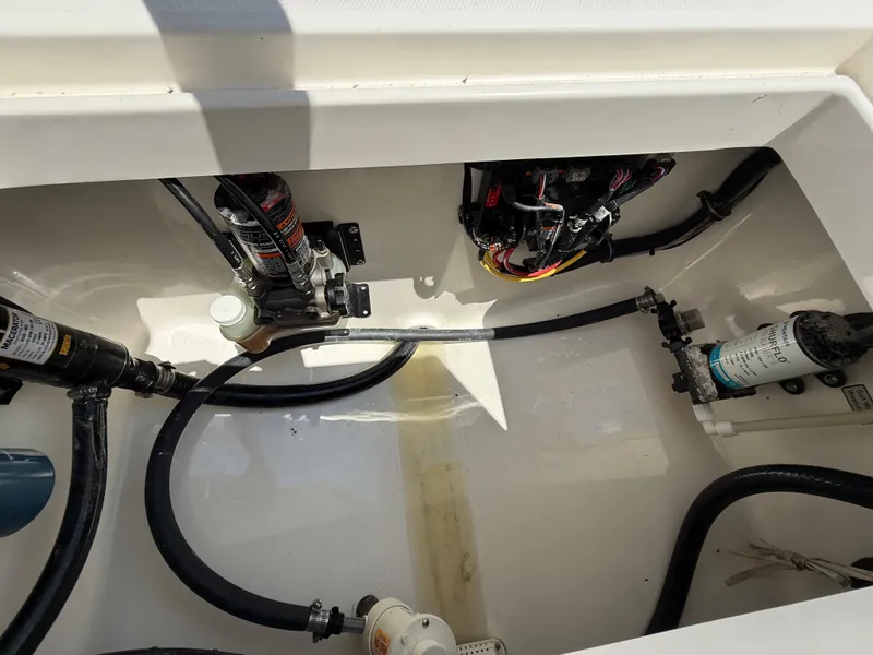 Slide: The Image of 2018 Regulator 23 boat interior showing wiring and pump system components. - 35