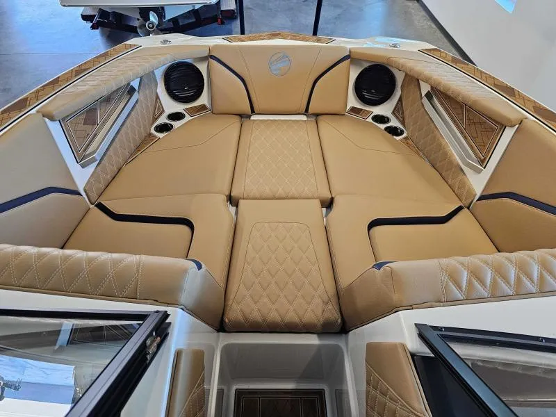 Slide: The Image of Luxurious interior of 2024 Tigé 24RZX boat with tan quilted seating and speakers. - 10