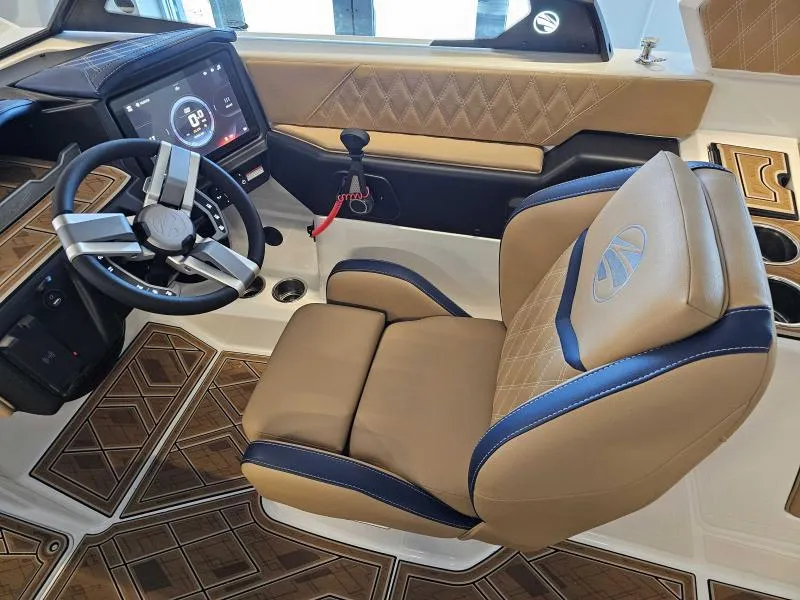 Slide: The Image of 2024 Tigé 24RZX boat interior with luxury captain's chair and modern dashboard. - 11