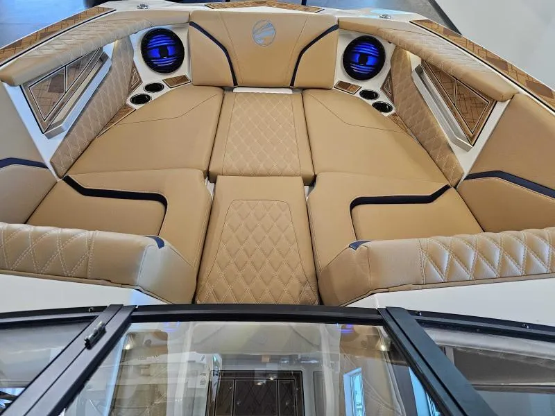 Slide: The Image of Luxurious interior of 2024 Tigé 24RZX boat with tan quilted seating and blue accents. - 12