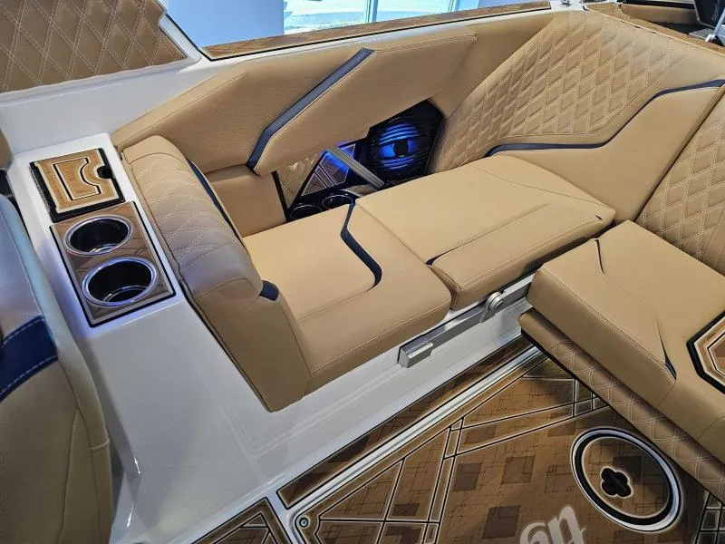 Slide: The Image of 2024 Tigé 24RZX boat interior with tan leather seats and cup holders. - 19