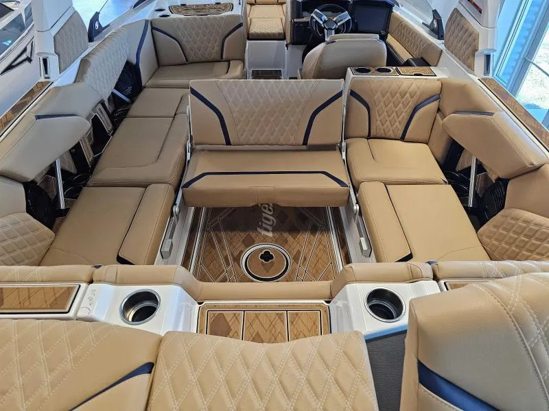 Slide: The Image of Luxurious interior of 2024 Tigé 24RZX boat with tan leather seating and wood accents. - 20