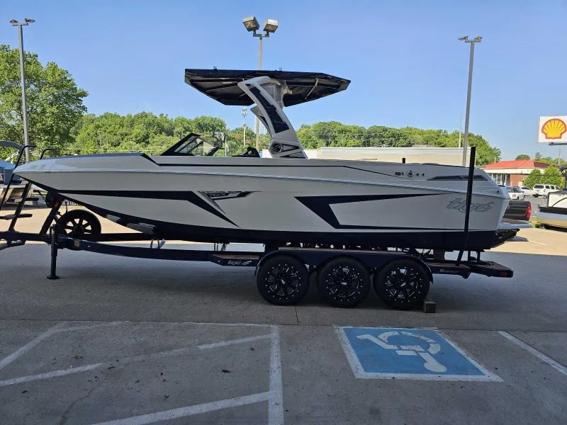 Slide: The Image of 2024 Tigé 24RZX boat on trailer in parking lot, clear sky background. - 4