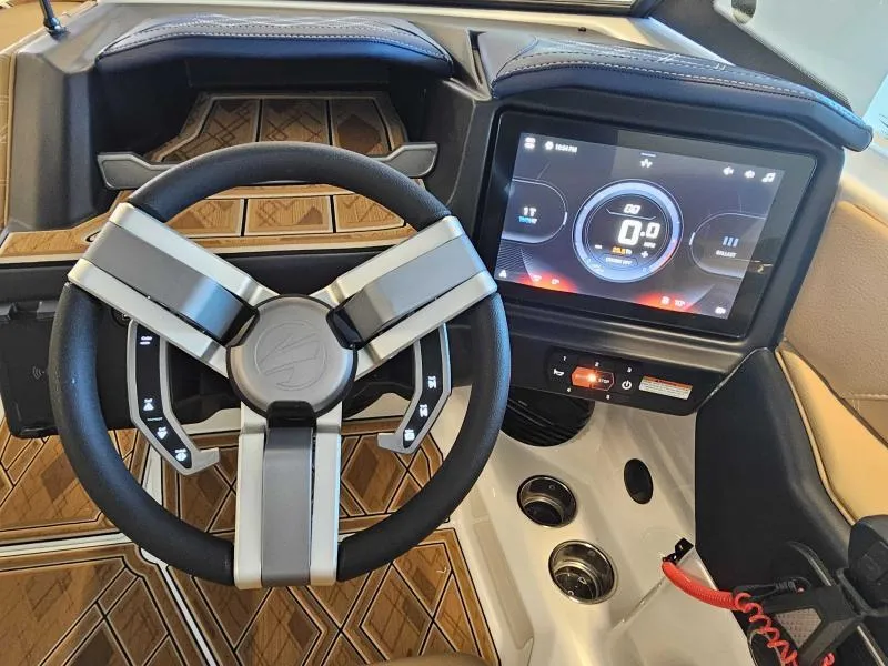 Slide: The Image of 2024 Tigé 24RZX boat dashboard with modern steering wheel and digital display. - 8