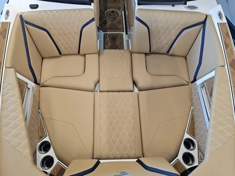 Slide: The Image of 2024 Tigé 24RZX boat interior with tan diamond-stitched seating and cup holders. - 9