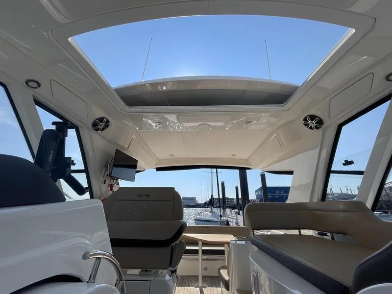 Slide: The Image of Interior view of 2019 Sea Ray 350 Sundancer Coupe with sunroof and seating. - 14