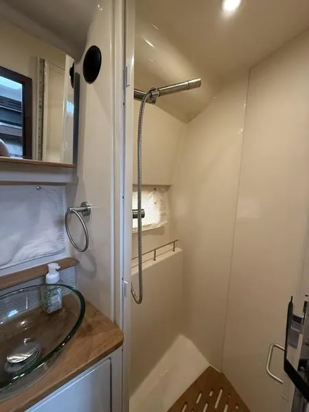 Slide: The Image of 2019 Sea Ray 350 Sundancer Coupe bathroom with modern shower and glass sink. - 20