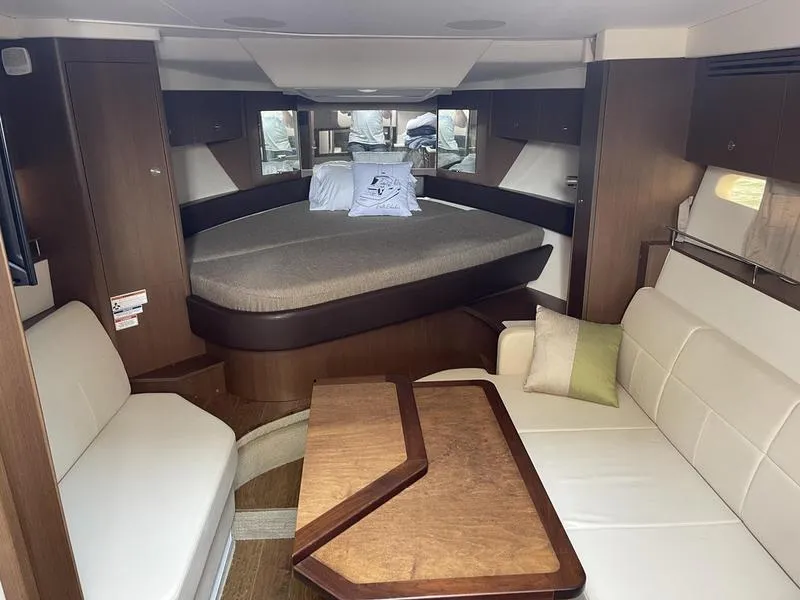 Slide: The Image of Interior of 2019 Sea Ray 350 Sundancer Coupe with cozy seating and elegant wood finishes. - 21