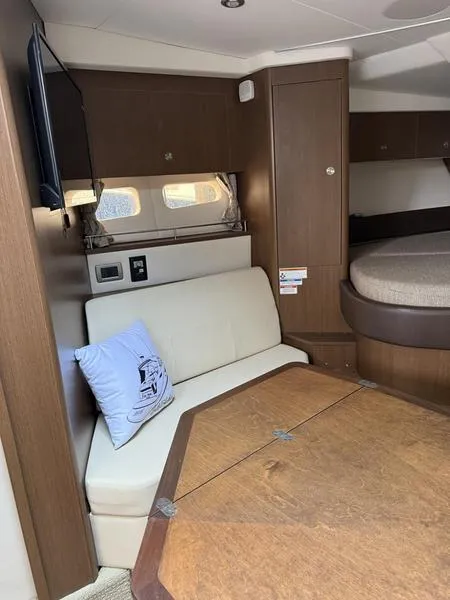 Slide: The Image of Interior of 2019 Sea Ray 350 Sundancer Coupe with seating and table. - 22