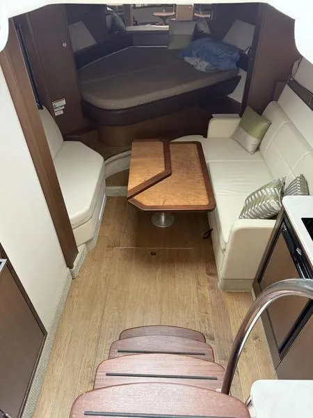 Slide: The Image of Interior of 2019 Sea Ray 350 Sundancer Coupe with seating and table. - 25