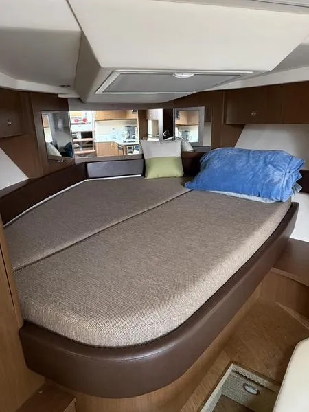 Slide: The Image of 2019 Sea Ray 350 Sundancer Coupe cabin interior with cozy bed and modern design. - 28