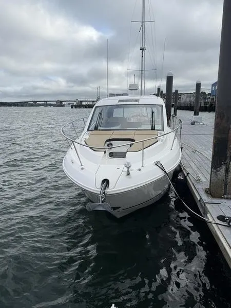 Slide: The Image of 2019 Sea Ray 350 Sundancer Coupe docked at a marina on a cloudy day. - 3