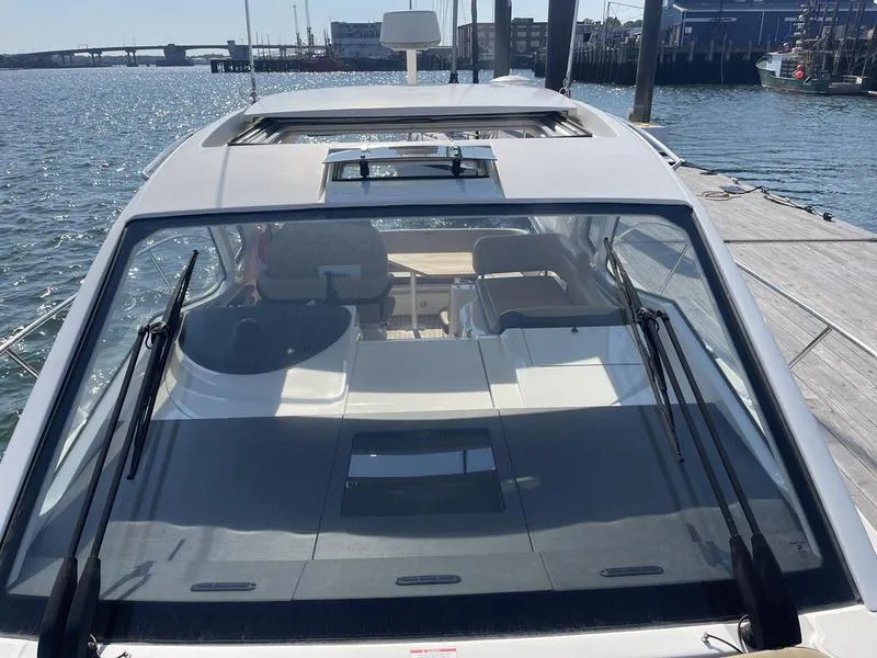 Slide: The Image of 2019 Sea Ray 350 Sundancer Coupe docked, showcasing sleek design and spacious interior. - 7