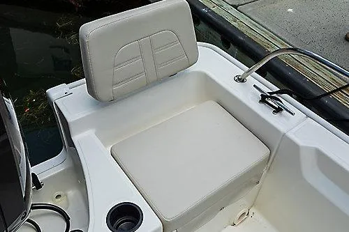 Slide: The Image of 2026 Boston Whaler 190 Montauk boat seating area with cup holder and railing. - 2