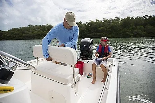 Slide: The Image of 2026 Boston Whaler 170 Montauk boat on water with two people enjoying a day out. - 4