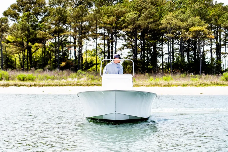 Slide: The Image of 1972 SeaCraft 20 Classic boat on water, with trees in the background. - 3