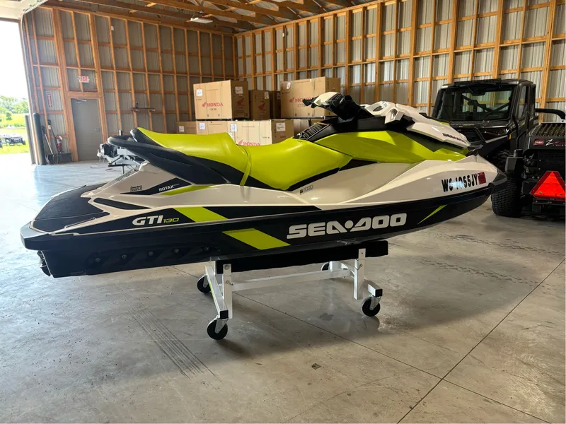 Slide: The Image of 2016 Sea-Doo GTI 130 jet ski in a garage, lime green and white design. - 2