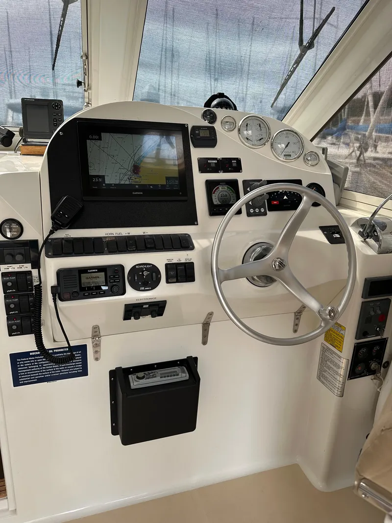 Slide: The Image of Control panel of 2002 True North 38 boat with navigation equipment and steering wheel. - 10