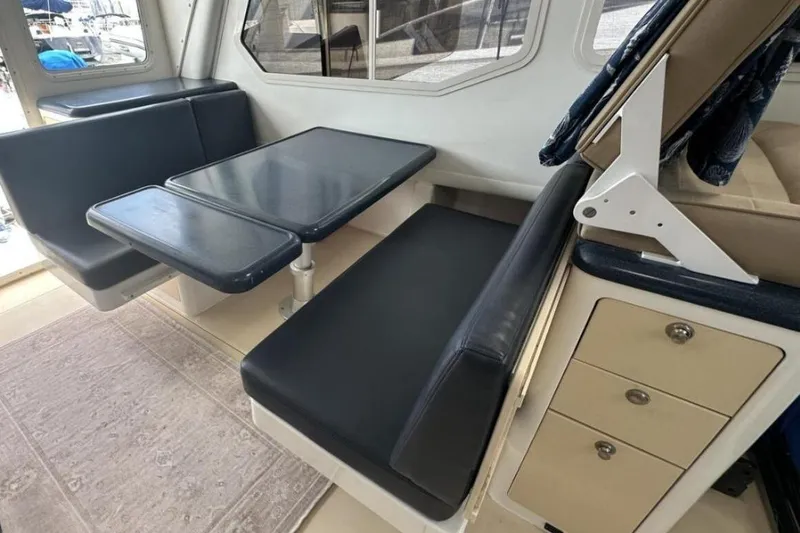 Slide: The Image of Interior of 2002 True North 38 boat with dining area and seating. - 17