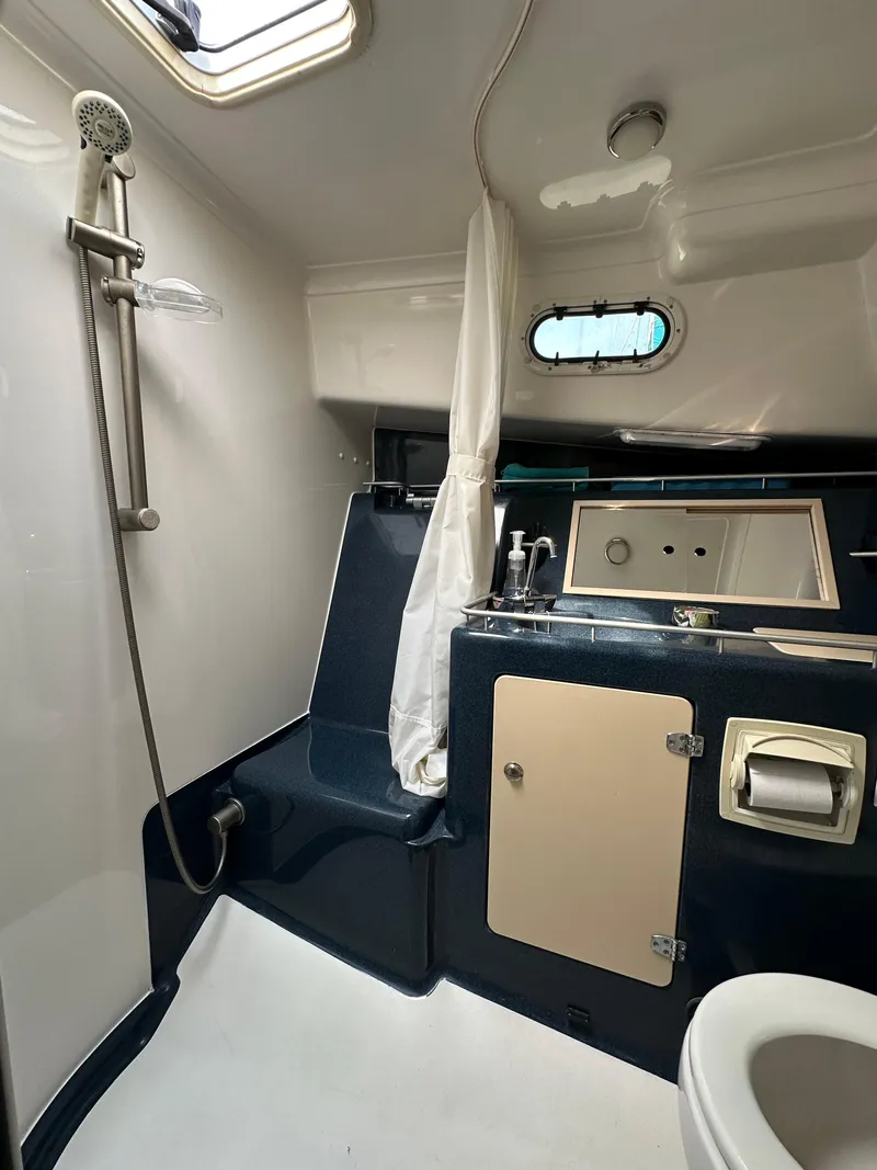 Slide: The Image of Bathroom interior of 2002 True North 38 yacht, featuring shower, sink, and toilet. - 25
