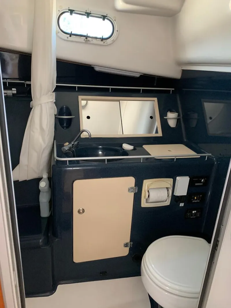 Slide: The Image of Compact bathroom in 2002 True North 38 boat with sink, toilet, and mirror. - 26