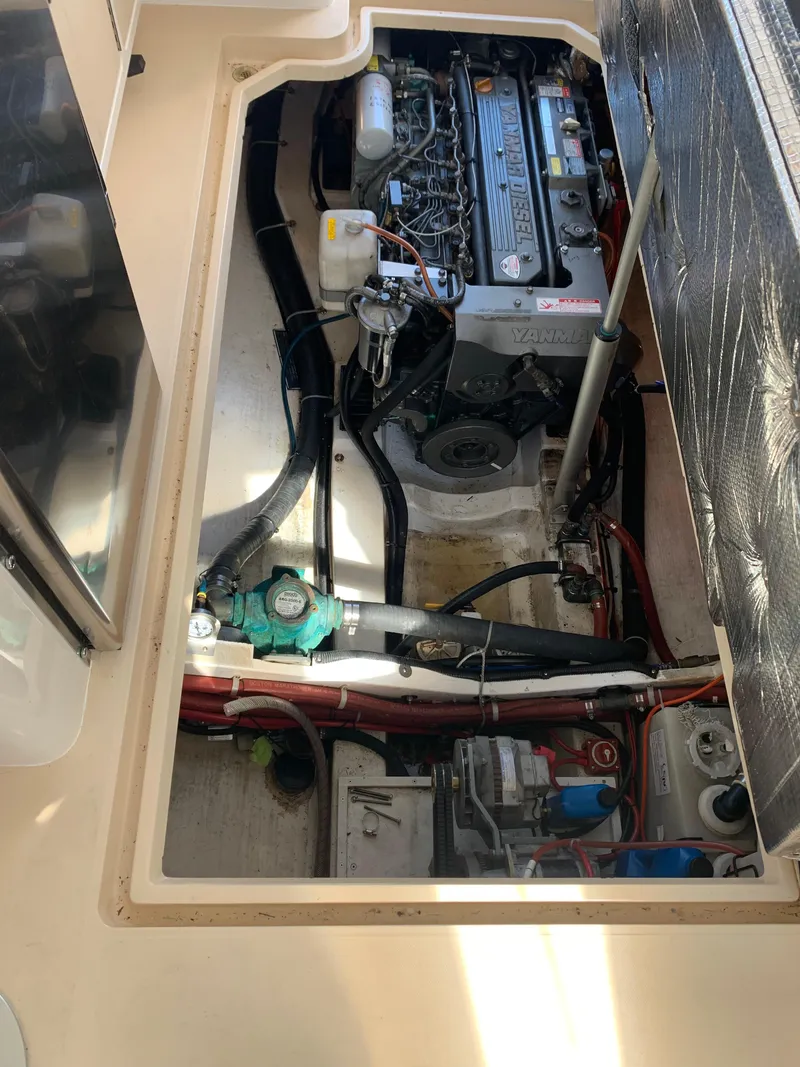 Slide: The Image of Engine compartment of a 2002 True North 38 boat, featuring a Yanmar diesel engine. - 30