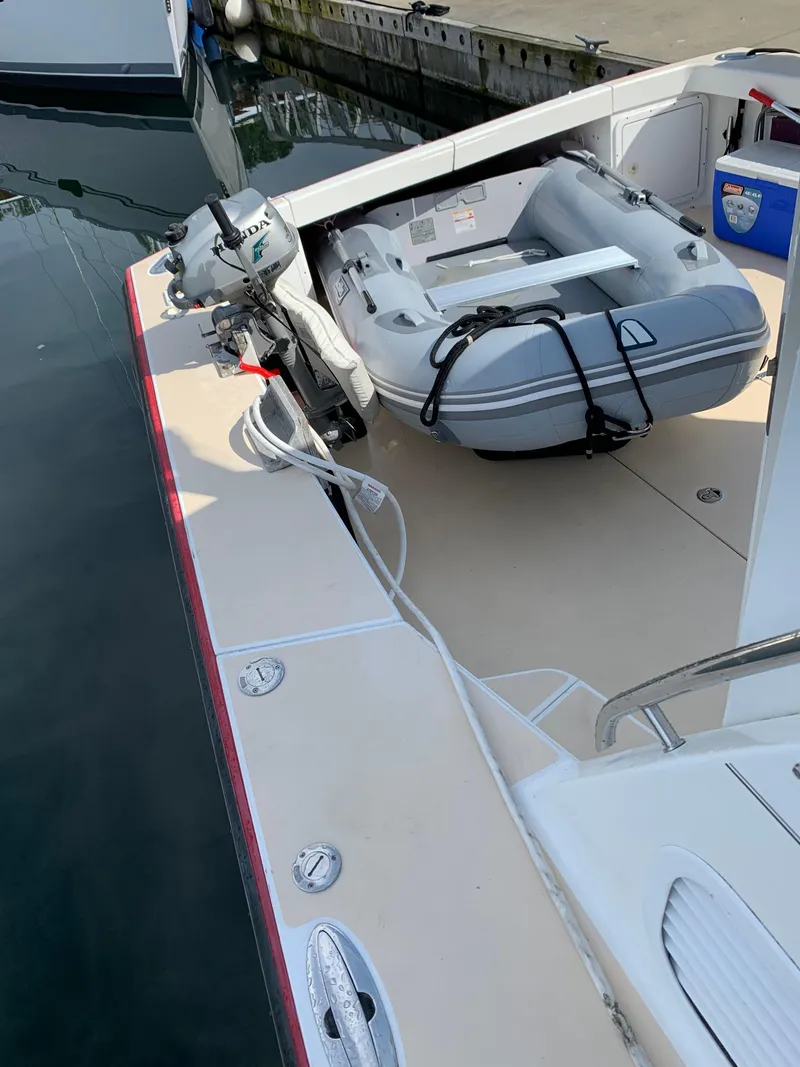 Slide: The Image of True North 38 boat deck with inflatable dinghy and Honda outboard motor, 2002 model. - 31