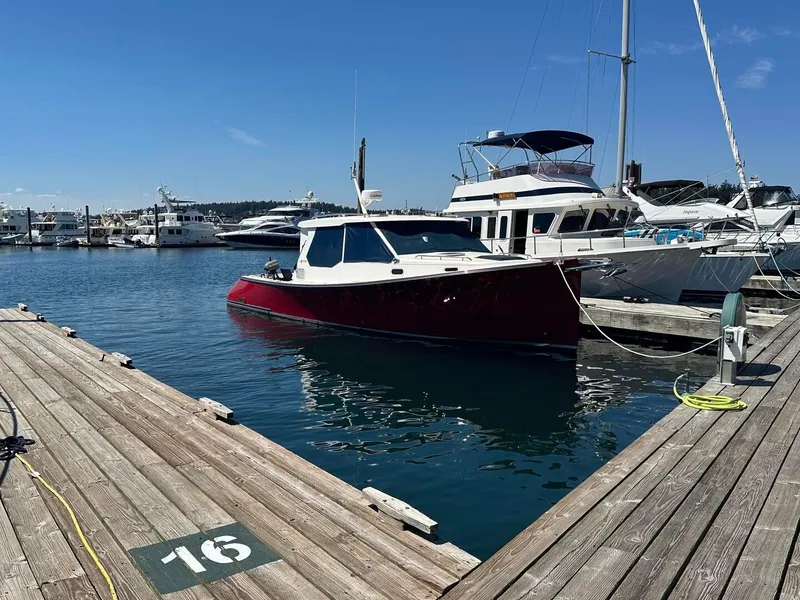 Slide: The Image of 2002 True North 38 boat docked at marina, clear blue sky, wooden pier. - 5