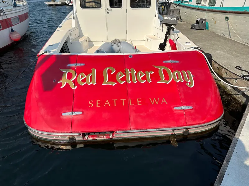 Slide: The Image of Red boat named "Red Letter Day" docked in Seattle, WA, True North 38 model. - 6