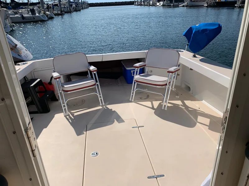 Slide: The Image of Deck of 2002 True North 38 boat with chairs overlooking marina. - 8
