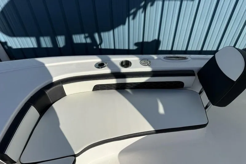 Slide: The Image of 2026 Tidewater 2300 Carolina Bay boat interior with cushioned seating and cup holders. - 10