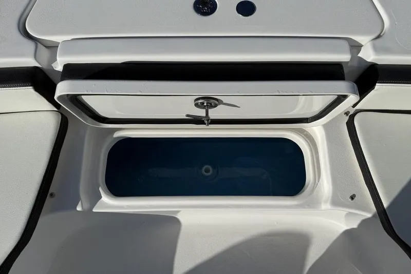 Slide: The Image of Livewell compartment on a 2026 Tidewater 2300 Carolina Bay boat, open and empty. - 12