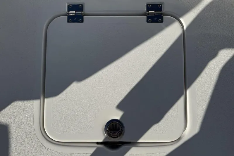 Slide: The Image of Hatch on 2026 Tidewater 2300 Carolina Bay boat, featuring metal hinges and latch. - 17