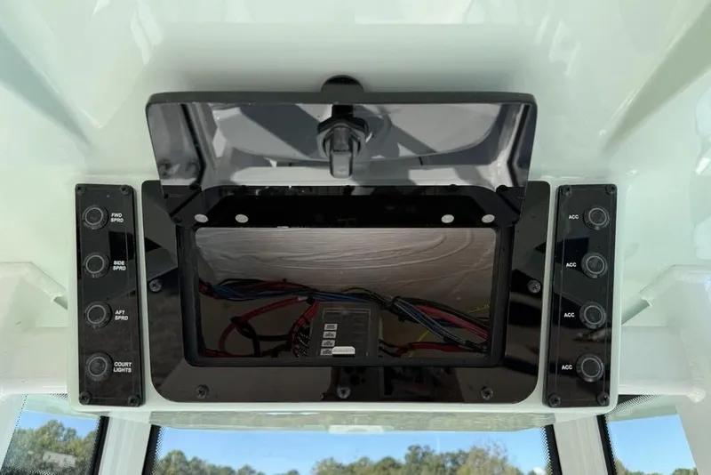 Slide: The Image of Control panel of 2026 Tidewater 2300 Carolina Bay boat with switches and wiring. - 18